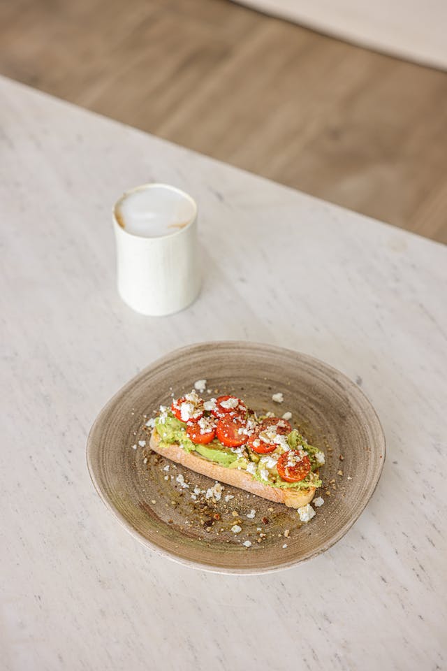 Smashed Avocado on Whole Grain Toast with Tomato Slices